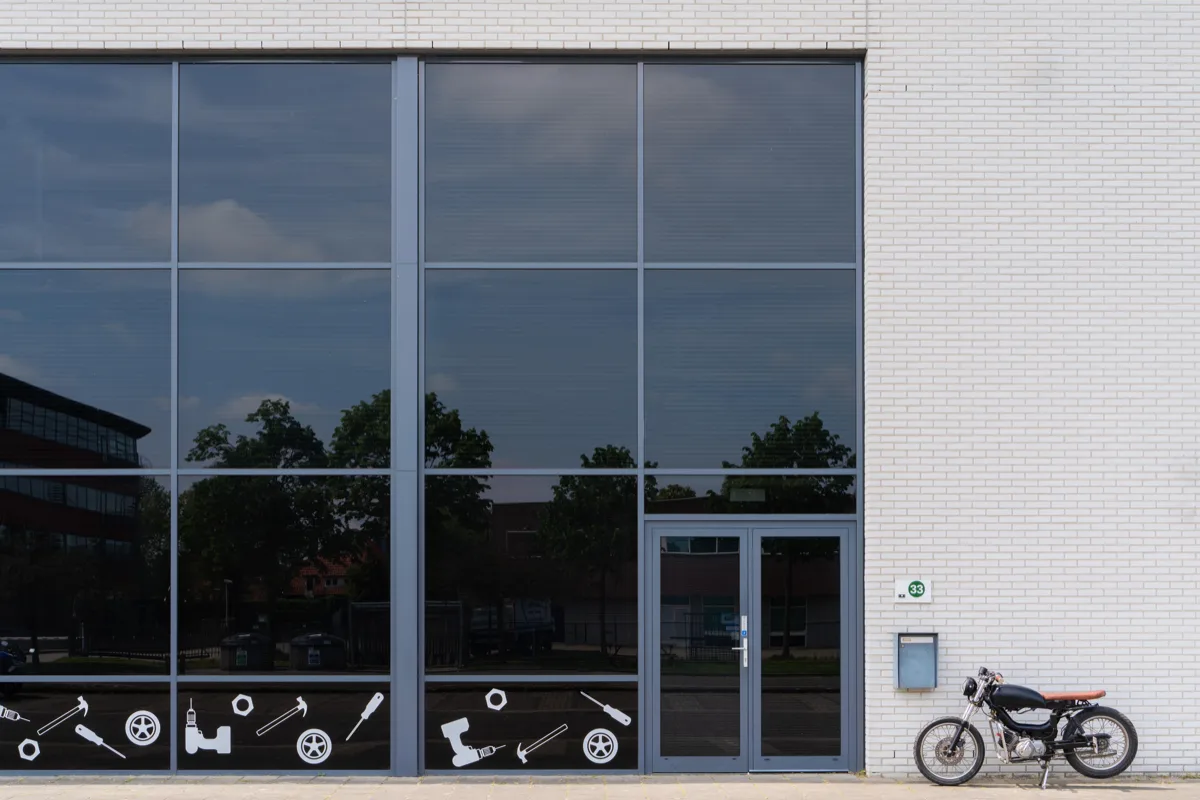 De ingang van het pand van De Werkhalte met een motor ervoor